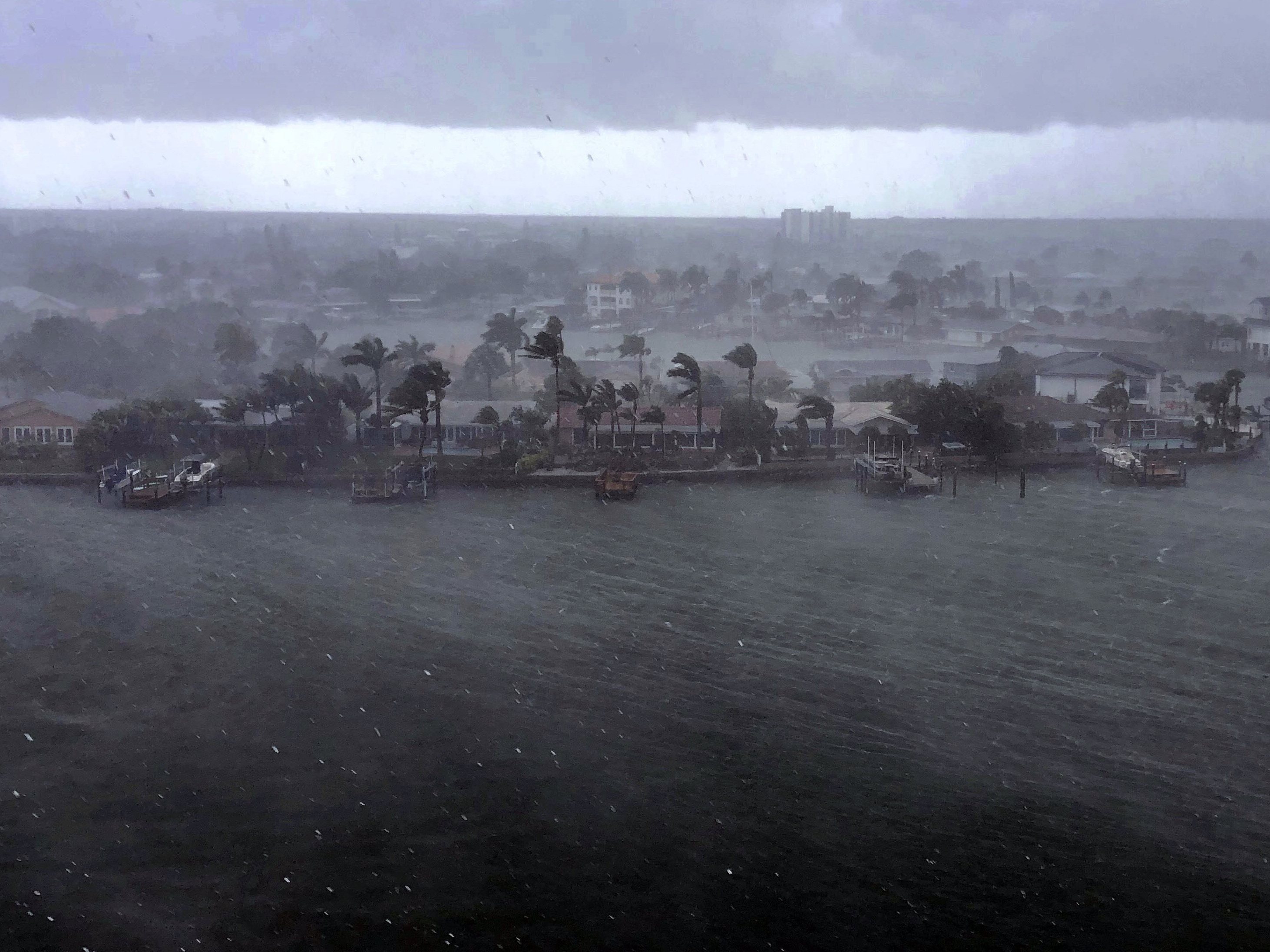 caption: Looking north at the neighborhood of Paradise Island on Treasure Island, Fla., outer bands of Tropical Storm Elsa brings a downpour of rain over the area on Tuesday, July 6, 2021.