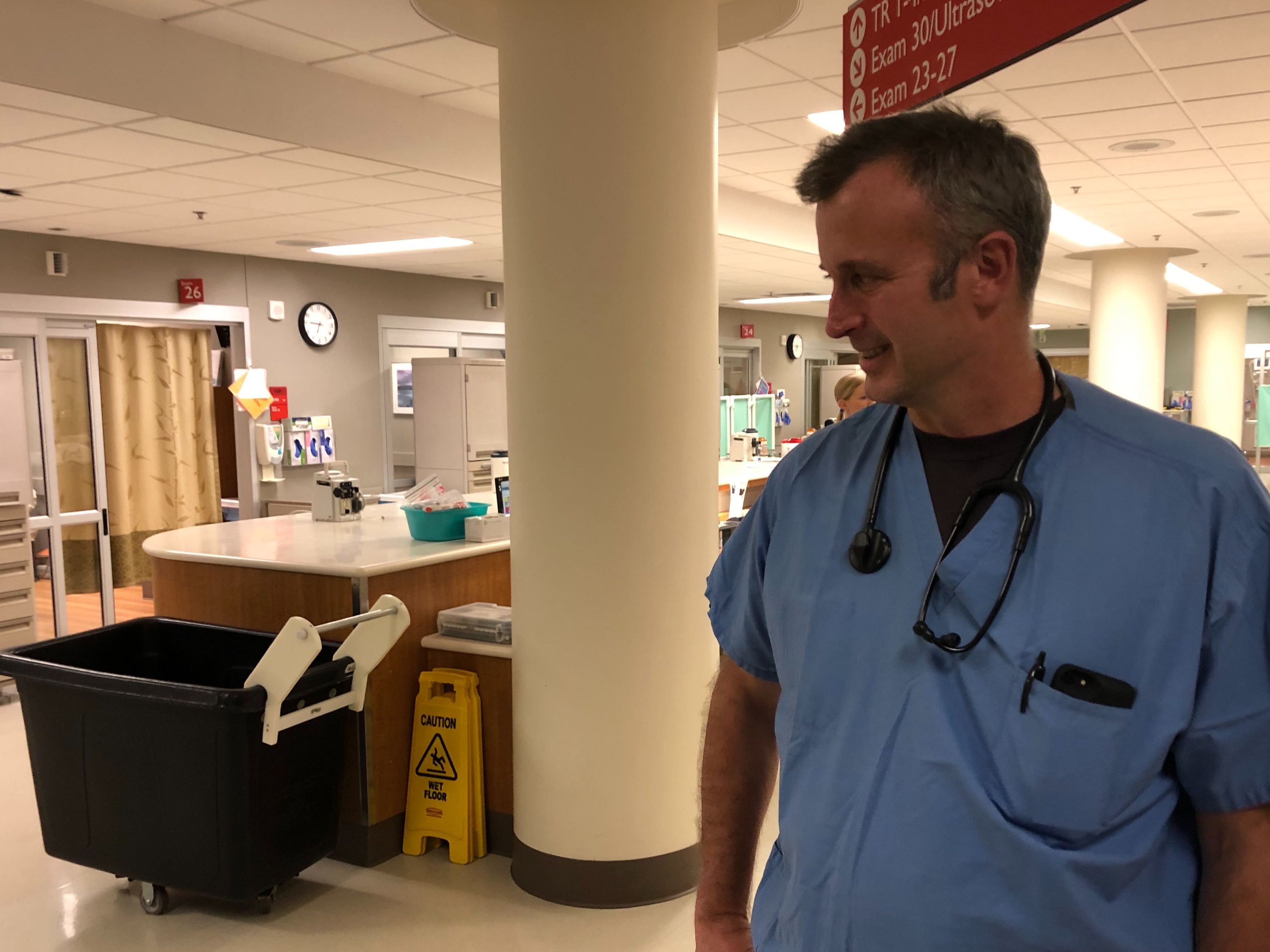 caption: Emergency physician Brad Younggren, in the emergency department at EvergreenHealth hospital in Kirkland, Wash., where he's been caring for patients with likely cases of COVID-19.