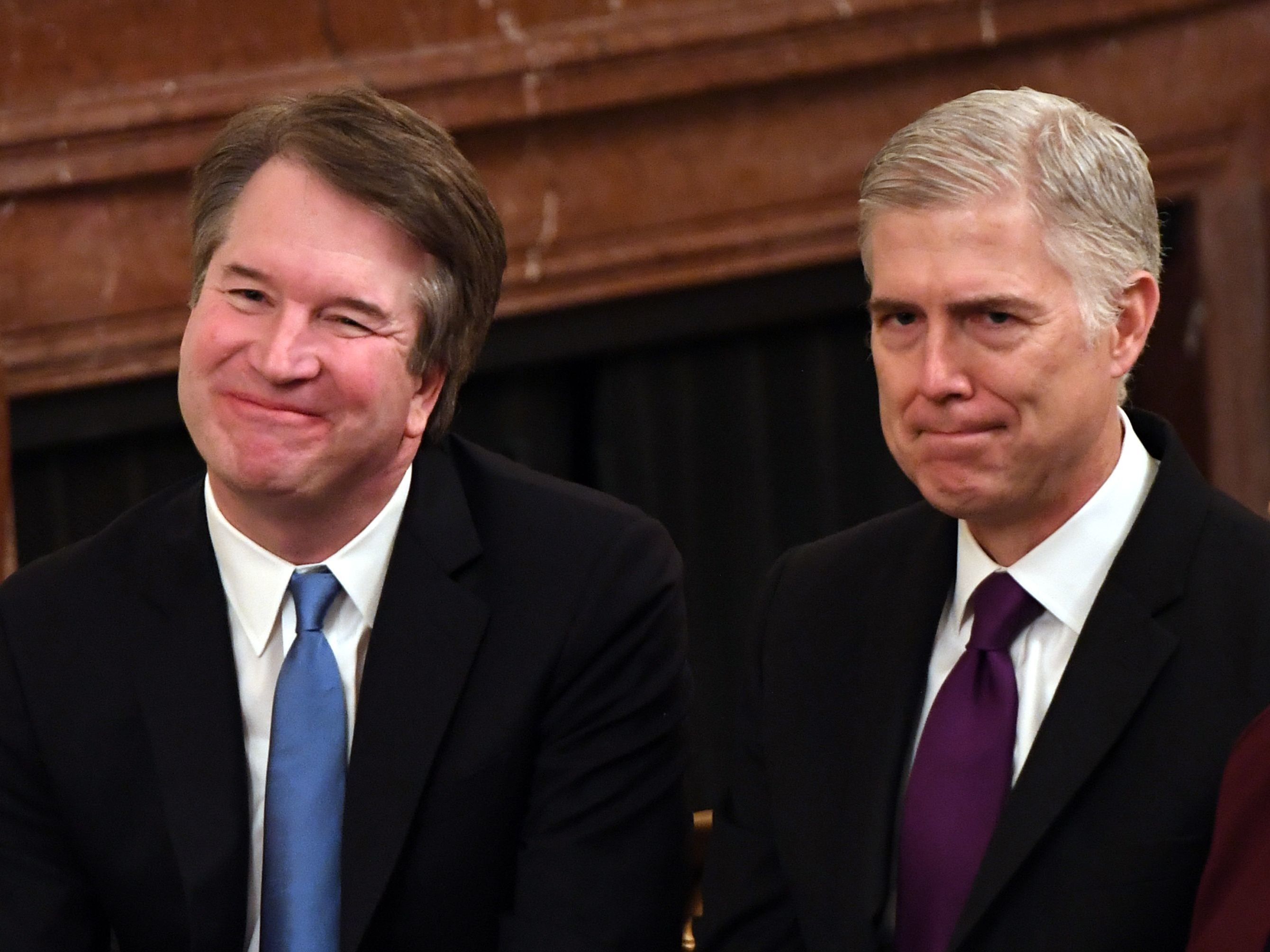 caption: Supreme Court justices Brett Kavanaugh (left) and Neil Gorsuch attend the Presidential Medal of Freedom ceremony at the White House last year.