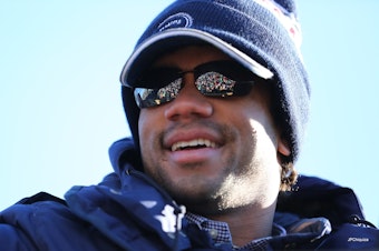 caption: Russell Wilson in downtown Seattle after the Seahawks won the Super Bowl in 2014. 