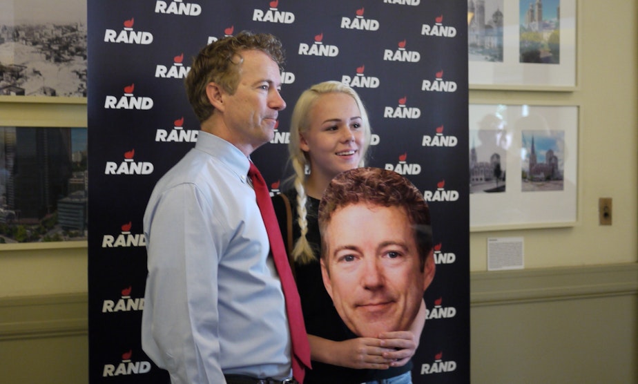 caption: Portland teen Angela Wilcox poses with presidential candidate Rand Paul at a rally in Seattle.