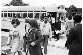 caption: As part of a Seattle Public Schools program, students were bused from different neighborhoods to improve racial mixes.