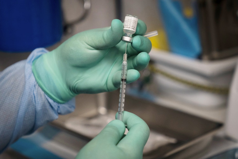 caption: In this Thursday, Aug. 26, 2021 file photo, a syringe is prepared with the Pfizer COVID-19 vaccine at a mobile vaccine clinic in Santa Ana, Calif. New U.S. studies released on Friday, Sept. 10, 2021 show COVID-19 vaccines remain highly effective, especially against hospitalizations and death, even against the extra-contagious delta variant. 