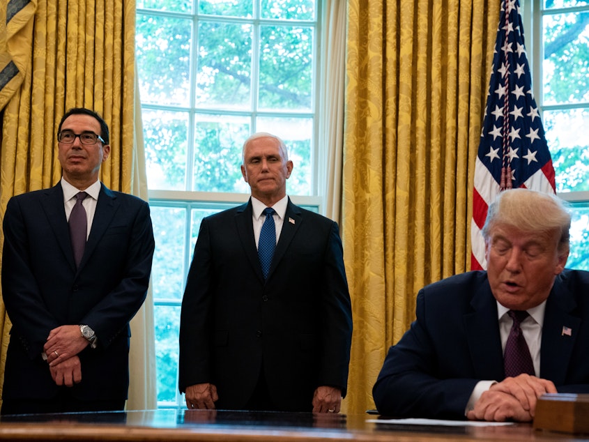 caption: President Trump, flanked by Treasury Secretary Steven Mnuchin (left) and Vice President Pence last month in the Oval Office. Pence and Mnuchin are in the immediate line of succession if Trump is not able to perform his duties.