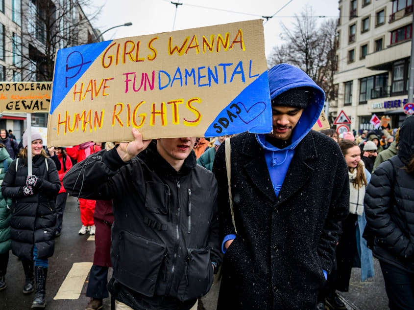 caption: Protesters march in Berlin to mark International Women's Day on Wednesday.