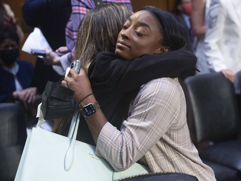 caption: United States gymnasts Kaylee Lorincz and Simone Biles hug after a Senate Judiciary hearing about the Inspector General's report on the FBI's handling of the Larry Nassar investigation on Sept. 15, 2021.