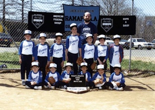 caption: Patrick Burleigh (center middle), pictured at age 6, stands with members of his Little League baseball team. (Courtesy of Patrick Burleigh)
