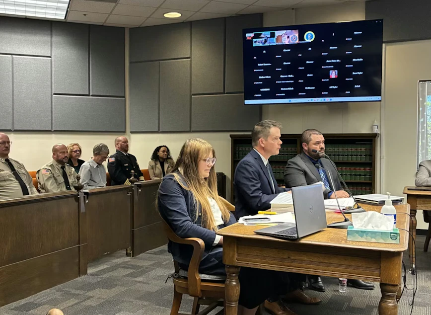 caption: Attorney Mark Lamb, who has been leading the lawsuit, speaks to the Thurston County judge on Wednesday. Behind him are the four sheriffs running for reelection he is representing.