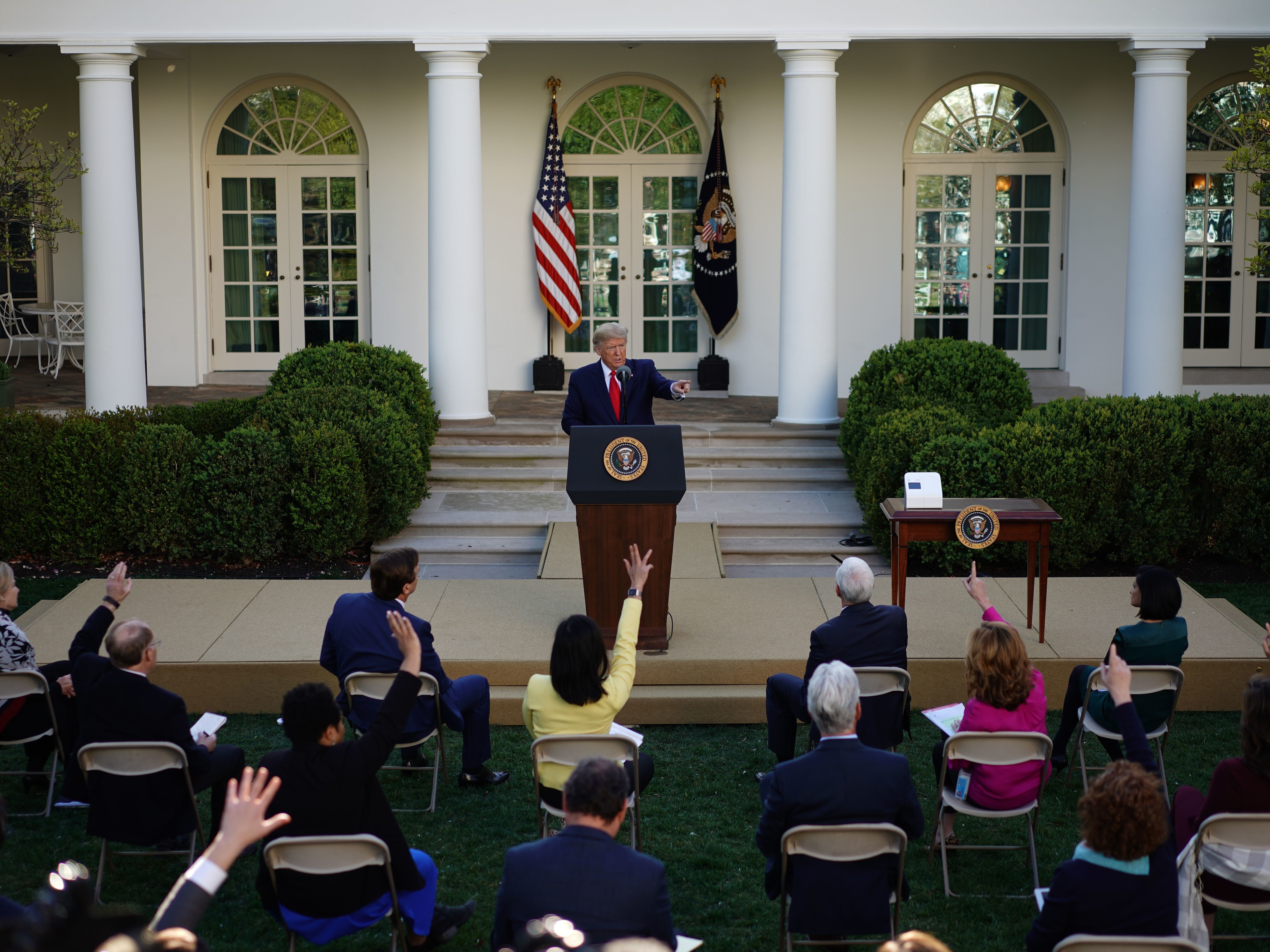 caption: President Trump takes questions from reporters during a Coronavirus Task Force press briefing in the Rose Garden of the White House on Monday.