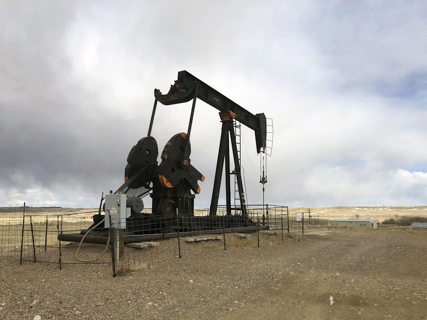 caption: An oil well is seen east of Casper, Wyo., on  Feb. 26, 2021. The Biden administration is raising royalty rates that companies must pay for oil and natural gas extracted from federal lands.