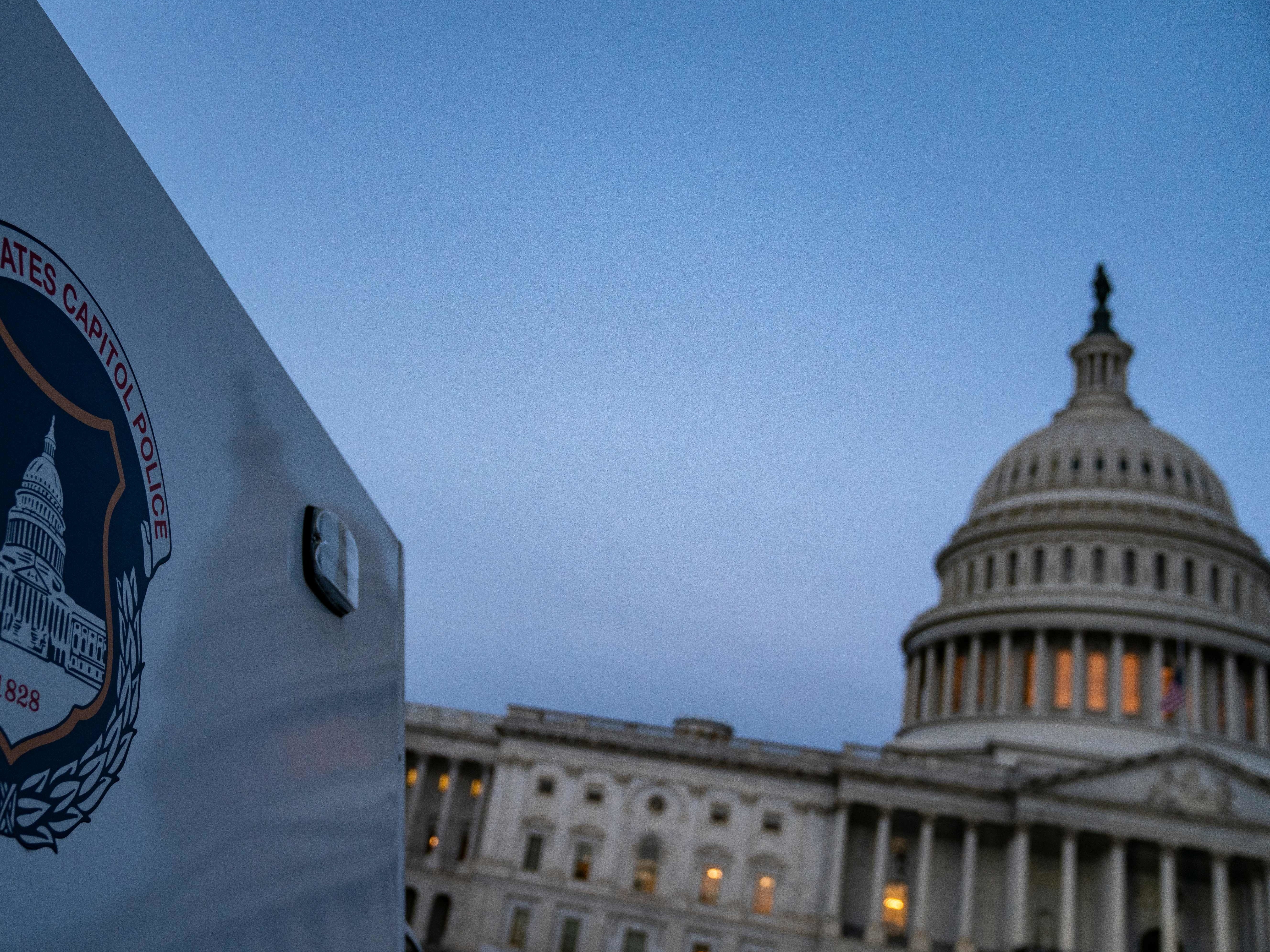 caption: The U.S. Capitol Building is seen at sunrise as the remains of U.S. Capitol Police officer Brian Sicknick lays in honor in the Rotunda on Feb. 3.