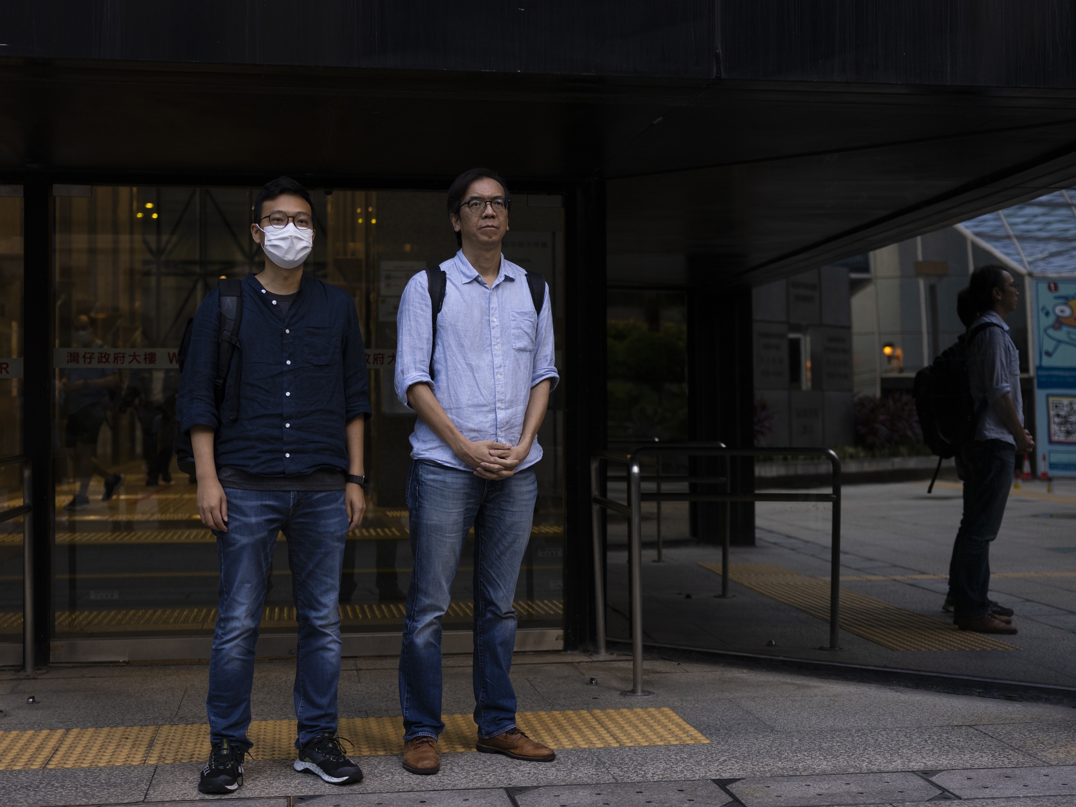 caption: Former chief editor Chung Pui-kuen, right, and former acting editor Patrick Lam, left, of the now-defunct independent media outlet Stand News leave the court on the last day of the publication's sedition trial closing statements in Hong Kong on June 28, 2023.