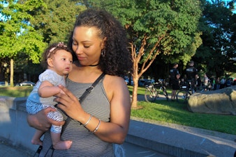 caption: Ricquel Sears of Capitol Hill with her 3-month-old daughter. For Sears, the Orlando shooting hit home. Her brother is gay, and her fiance is Muslim. 