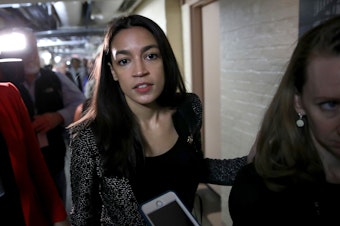 caption: Rep. Alexandria Ocasio-Cortez leaves a House Democratic caucus meeting on May 22 in Washington. She and Sen. Ted Cruz vowed on Twitter to work together to ban members of Congress who leave office from lobbying.