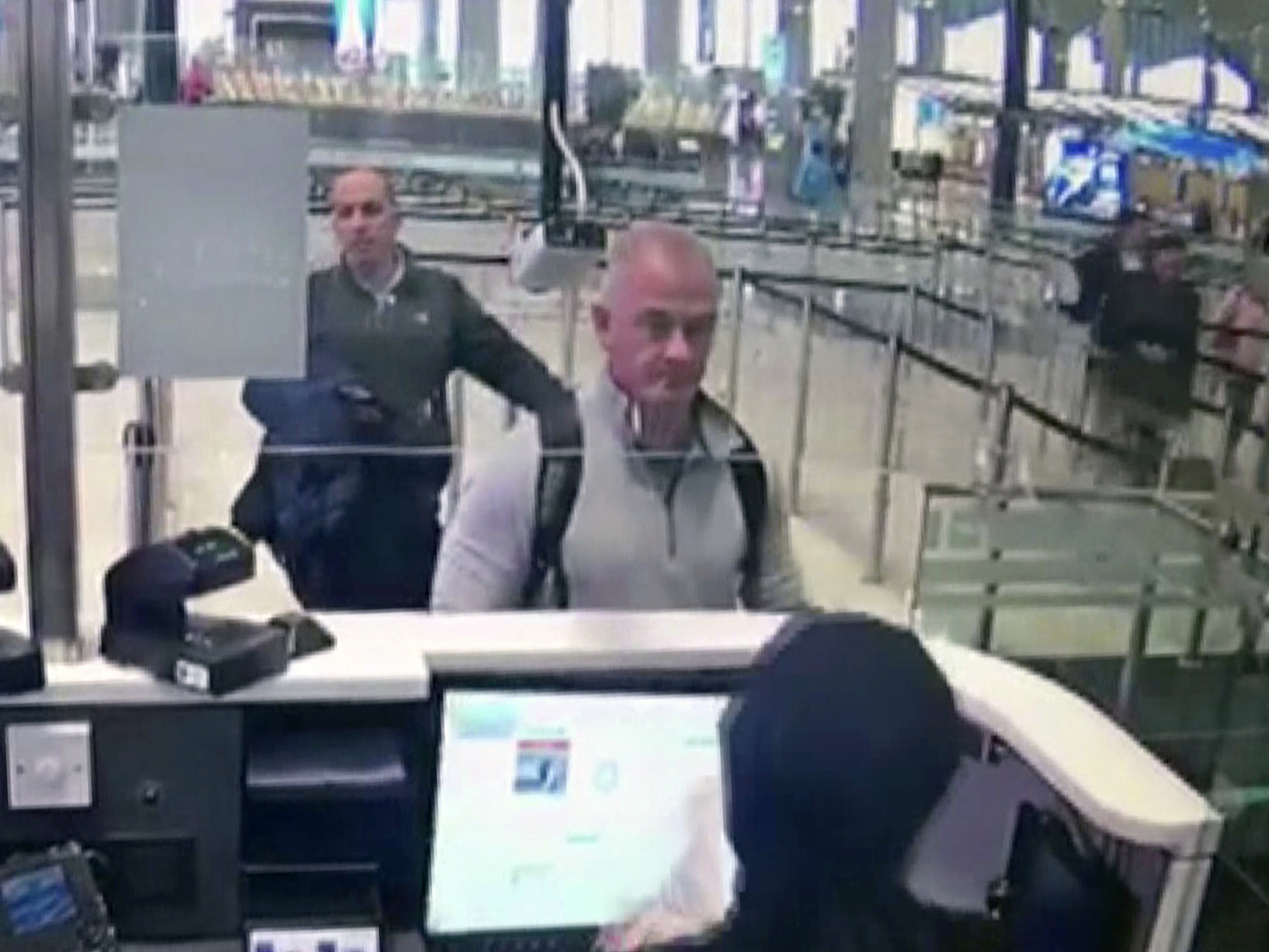 caption: This Dec. 30, 2019, image from security camera video shows Michael L. Taylor, center, and George-Antoine Zayek at passport control at Istanbul Airport in Turkey. A Tokyo court handed down prison terms for the American father Michael Taylor and son Peter accused of helping Nissan's former chairman, Carlos Ghosn, escape to Lebanon while awaiting trial in Japan.