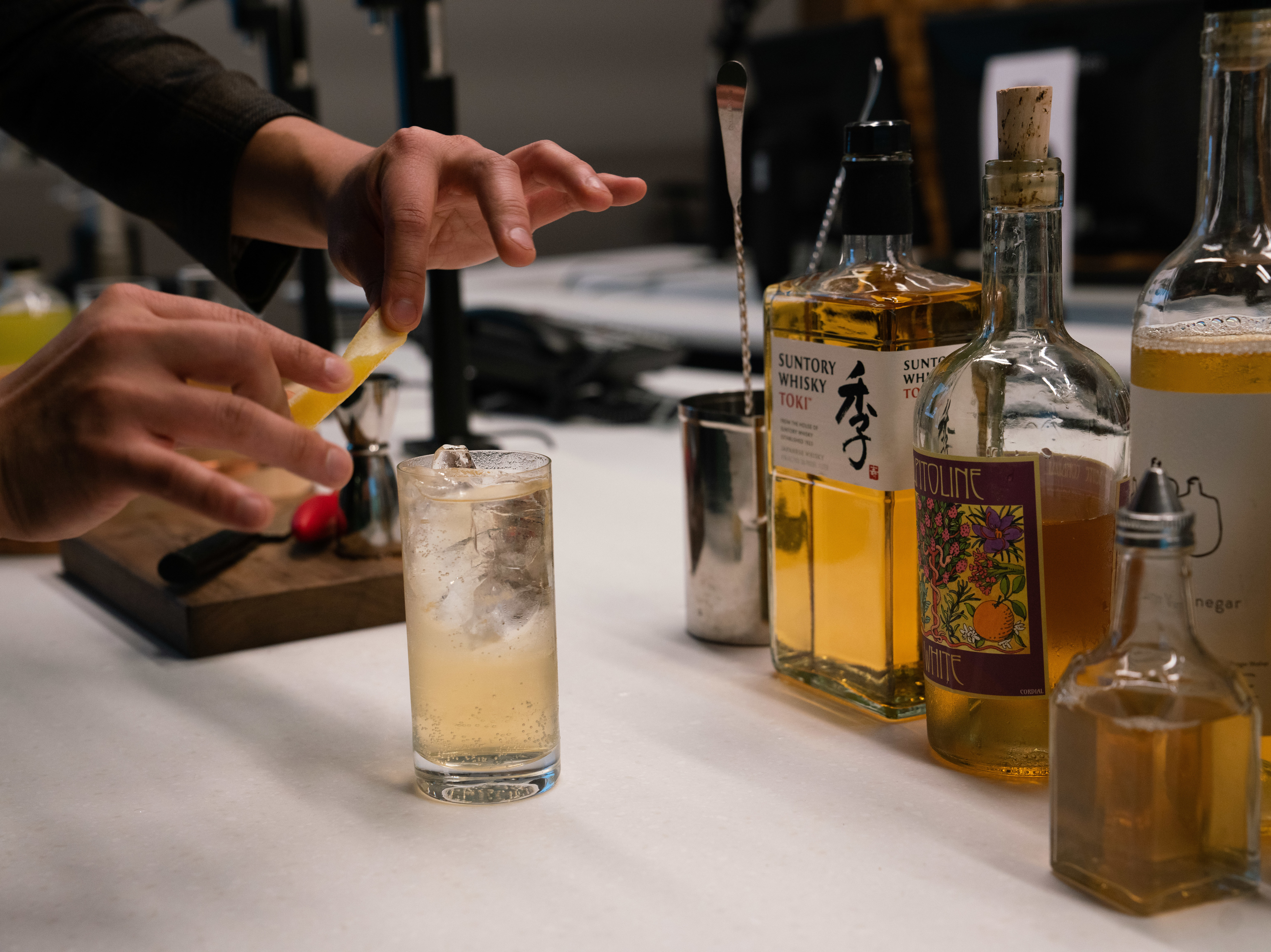 caption: Barman Eddie Kim created the light and crisp "Truth and Clarity" cocktail — combining Capitoline White Vermouth, Suntory Toki Whisky, club soda and lemon vinegar — to ring in the new year.