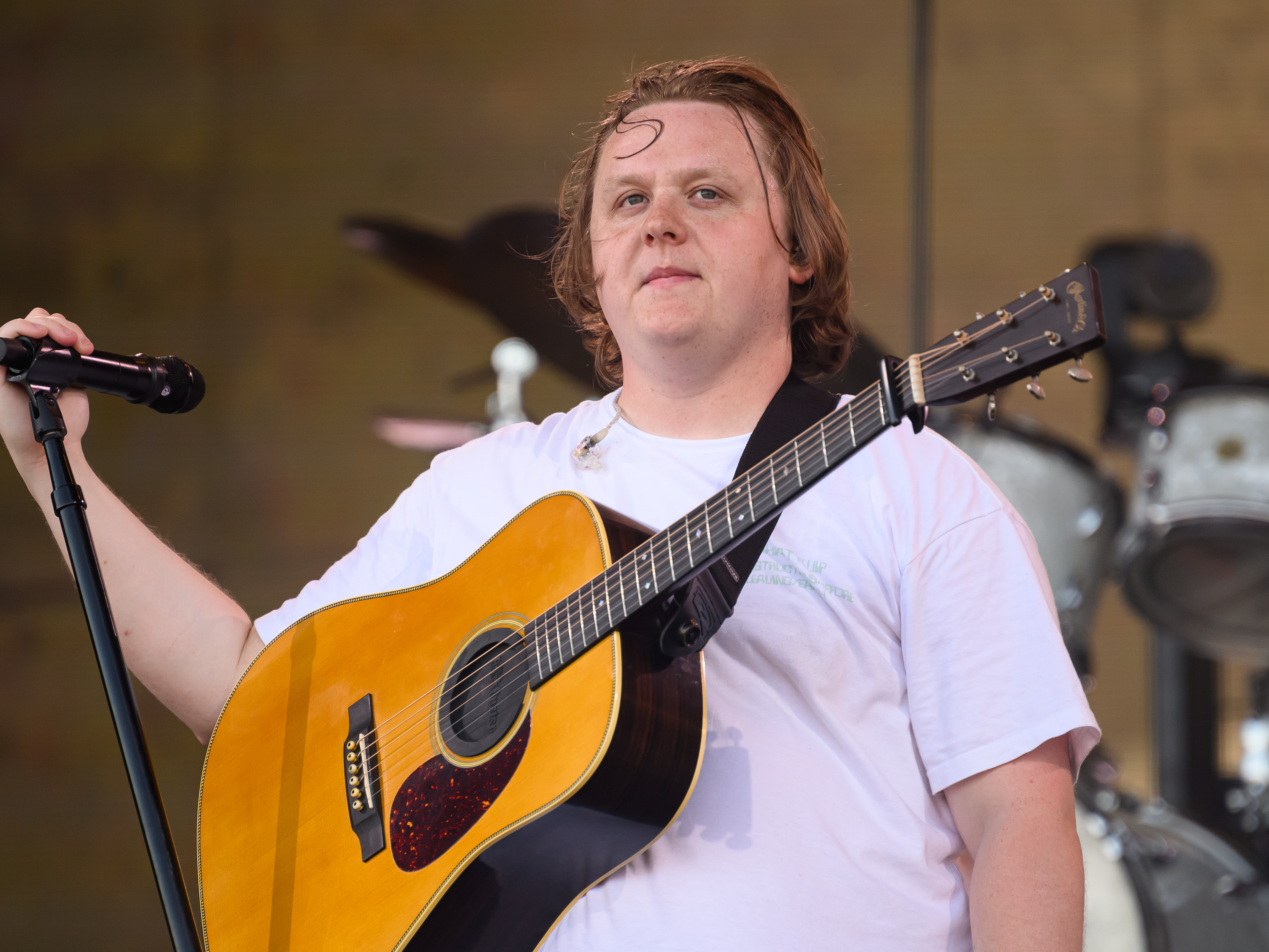caption: Lewis Capaldi performs on the Pyramid Stage on Day 4 of Glastonbury Festival.