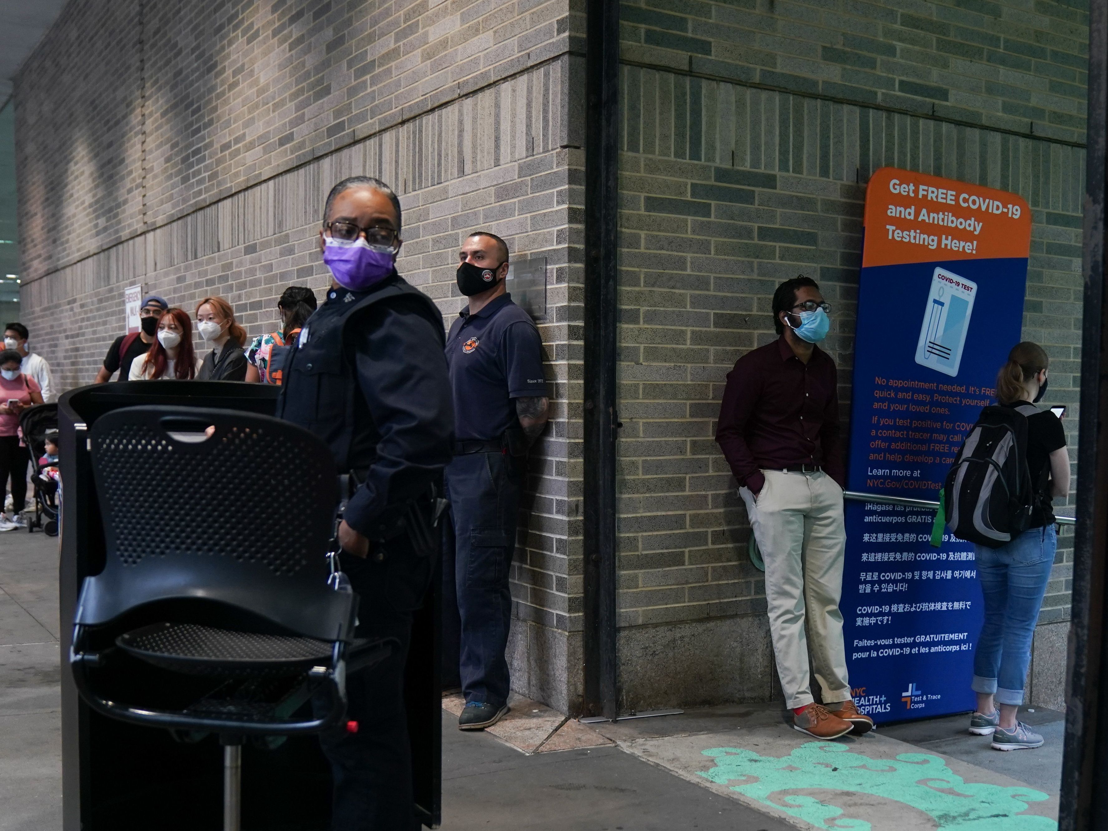 caption: People stand in line for free coronavirus testing this month at Bellevue Hospital in New York City. The daily number of new coronavirus cases reported in the U.S. has remained stubbornly high.