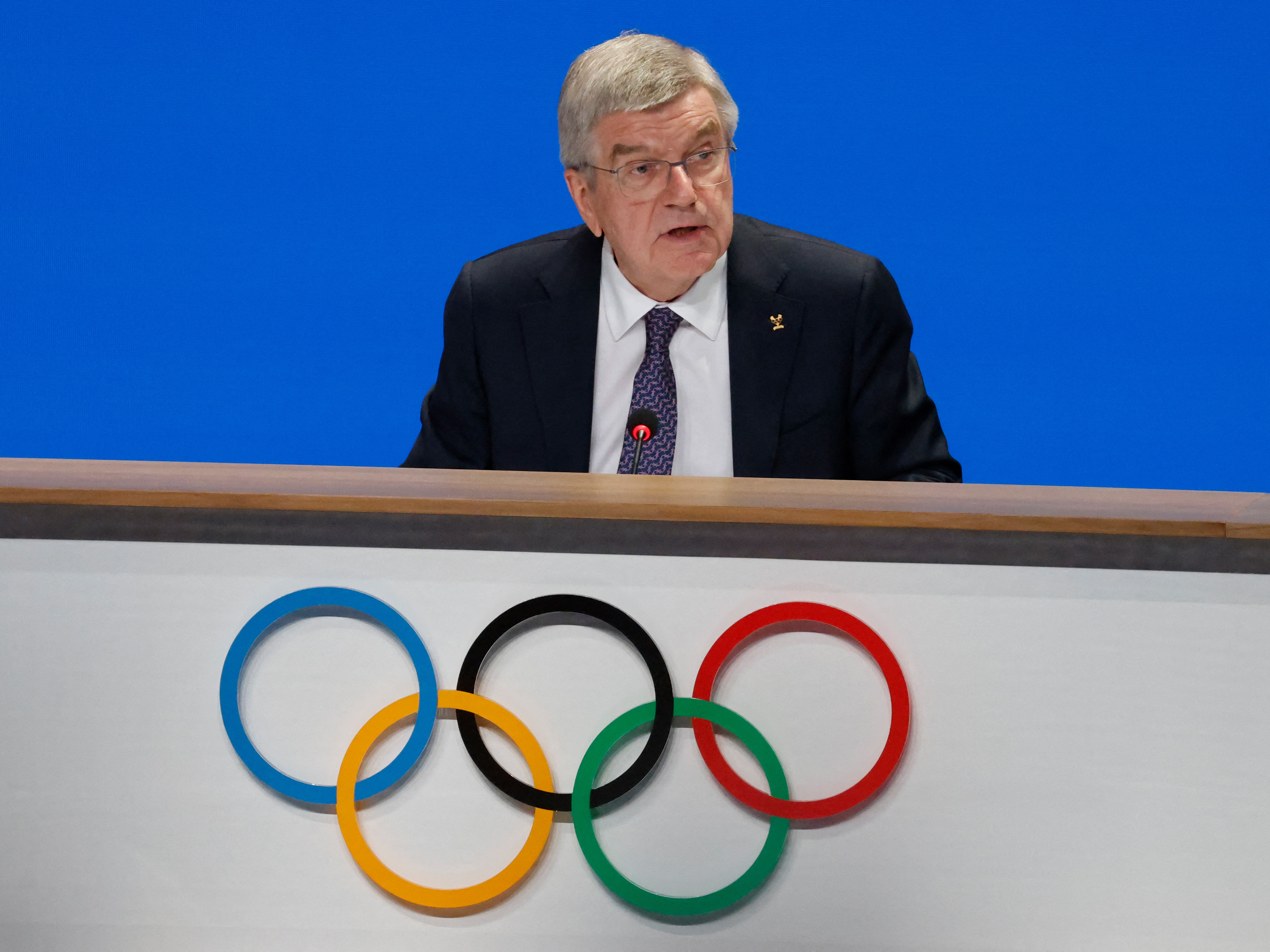caption: International Olympic Committee President Thomas Bach speaks during the 142nd session of the IOC in Paris on Wednesday, ahead of the Paris 2024 Olympic Games.
