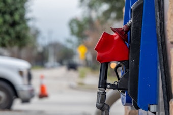 caption: A gas pump is seen in a station on Feb. 1 in Houston. Gasoline prices hit a new national record, not adjusted for inflation, surpassing the previous peak set around two months ago.