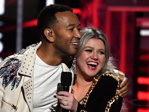caption: John Legend and Kelly Clarkson, onstage during the 2018 Billboard Music Awards at MGM Grand Garden Arena on May 20, 2018 in Las Vegas, Nevada.