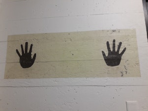 caption: Two hands are painted on the wall mark the area where detainees are supposed put their own before they were processed at the former INS building.