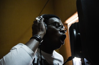 caption: Babacar Niang, known as Matador, raps at a recording studio at one of Africulturban's facilities in Pikine, Senegal on April 26, 2018.