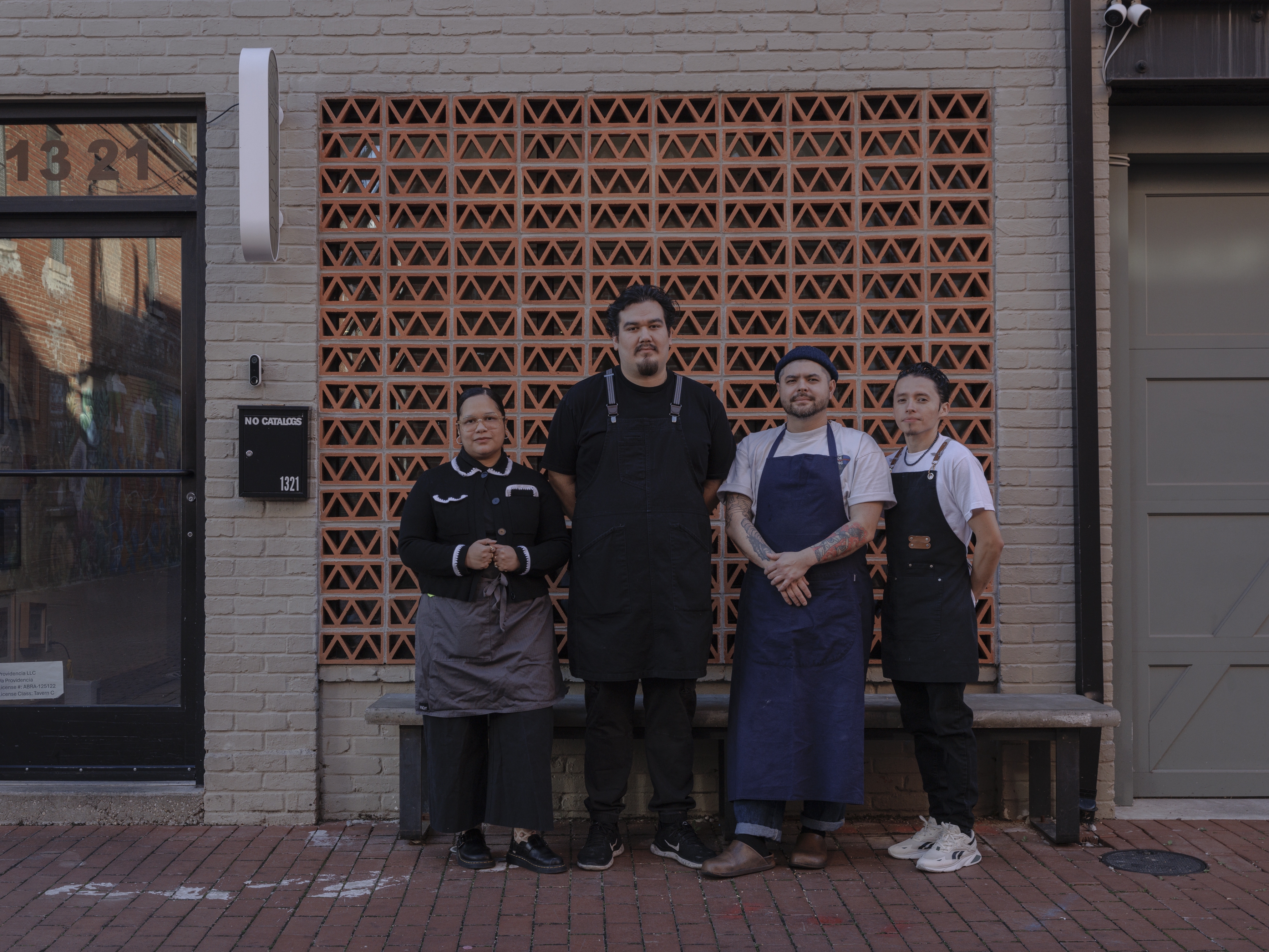 caption: From left to right, Paola Velez, Pedro Tobar, Erik Bruner-Yang and Daniel Gonzalez pose for a photo outside the newly opened alley bar Providencia in Washington, D.C., on Dec. 12.