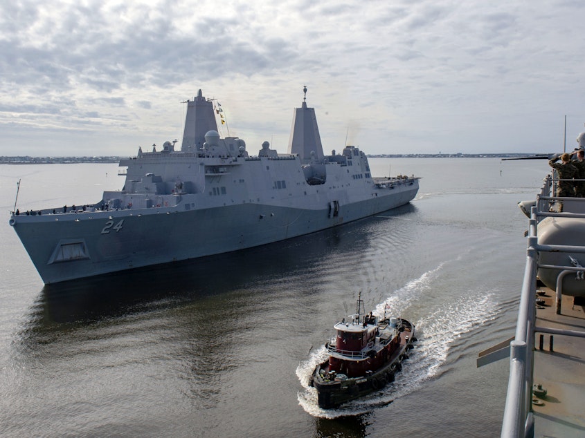 caption: The USS Arlington, shown in December in Morehead City, N.C., has been sent to the Middle East to bolster an aircraft carrier force sent to counter alleged threats from Iran.