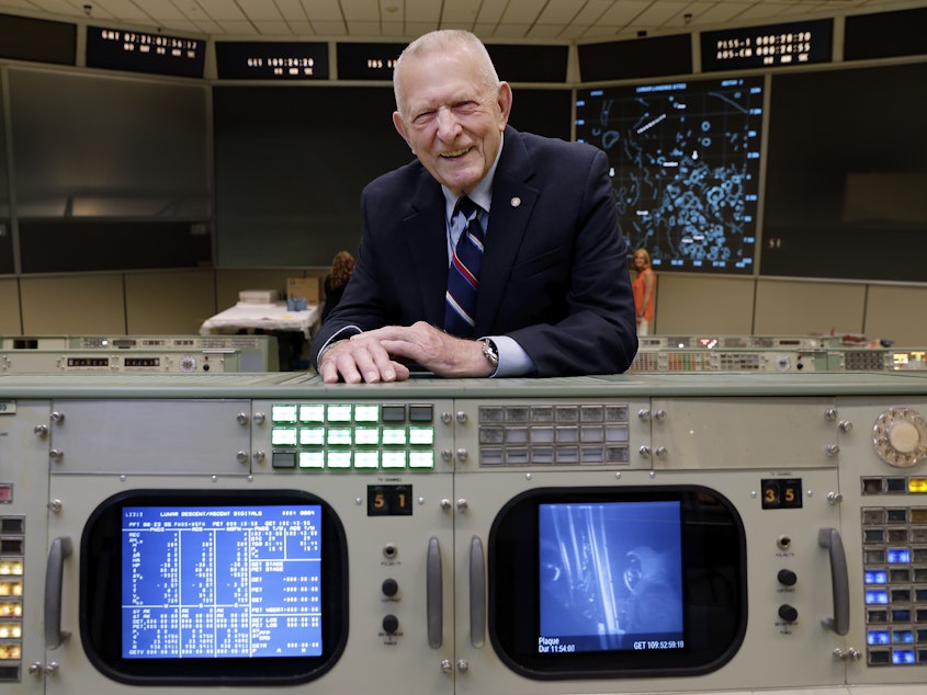 caption: Gene Kranz stands behind the console at Mission Control in Houston where he worked during the Gemini and Apollo missions.