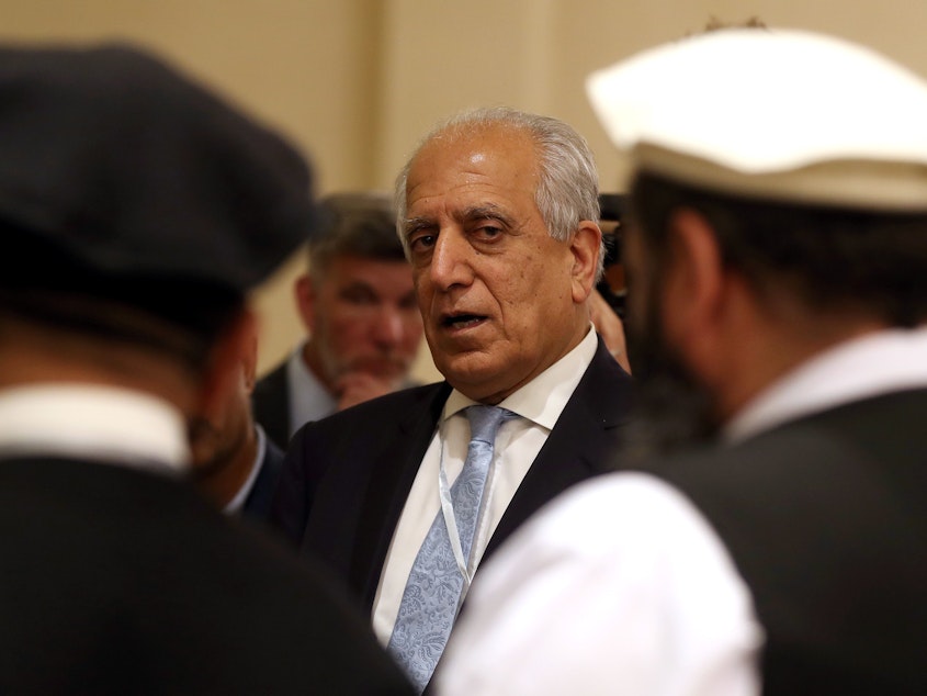 caption: U.S. Special Representative for Afghanistan Reconciliation Zalmay Khalilzad attends the Intra-Afghan Dialogue talks in the Qatari capital, Doha, in July.