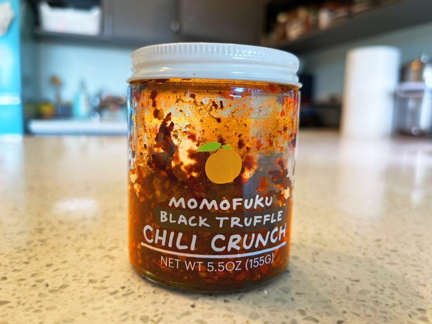 caption: A jar of Momofuku's black truffle chili crunch.