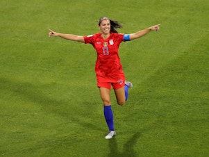 caption: Alex Morgan celebrates during the 2019 FIFA Women's World Cup semifinal. 