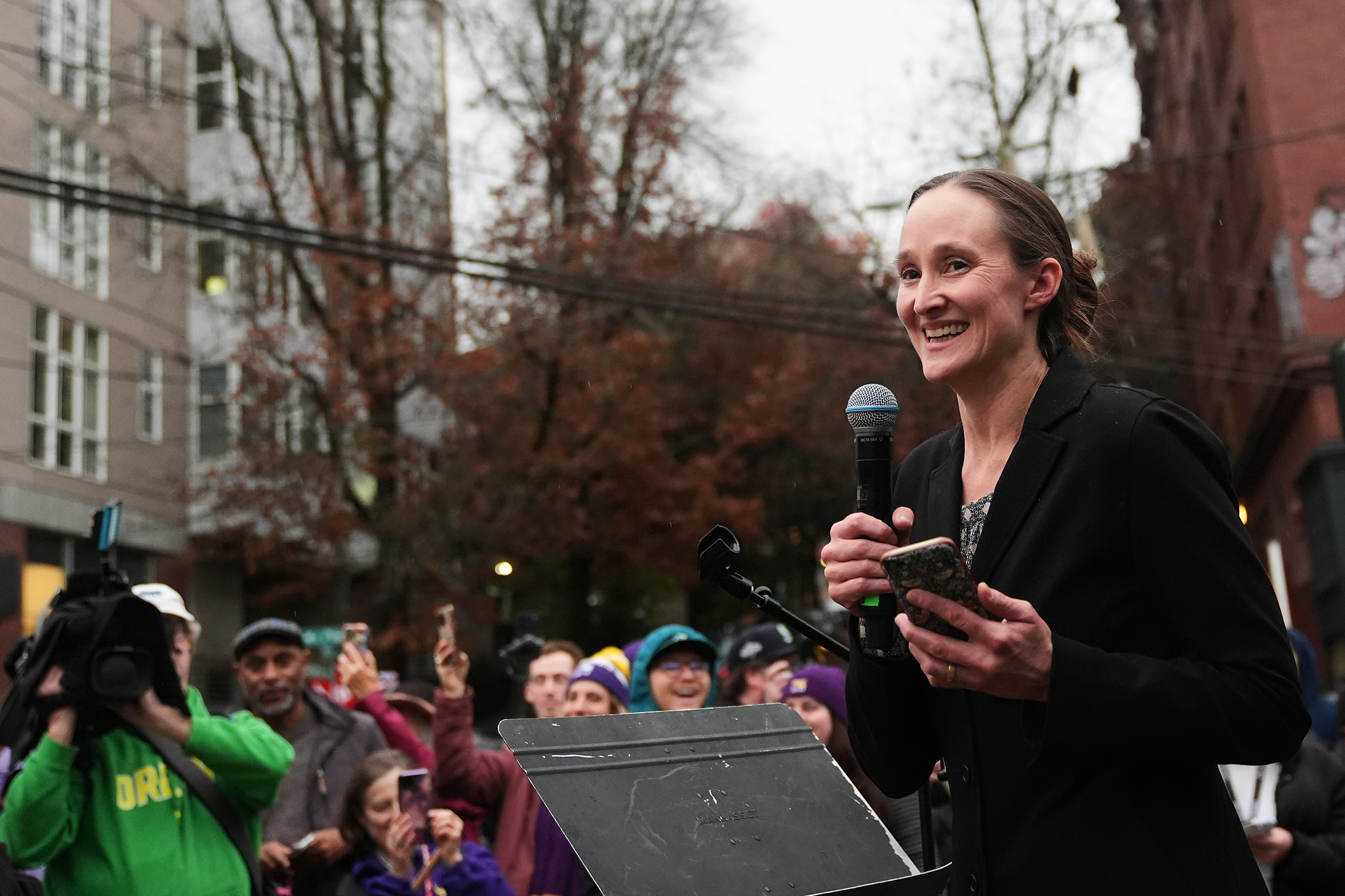 caption: Seattle mayor-elect Katie Wilson speaks to Starbucks employees and supporters as they gather to strike in front of the former Starbucks Reserve Roastery that closed earlier in the year, Thursday, Nov. 13, 2025, in Seattle. 