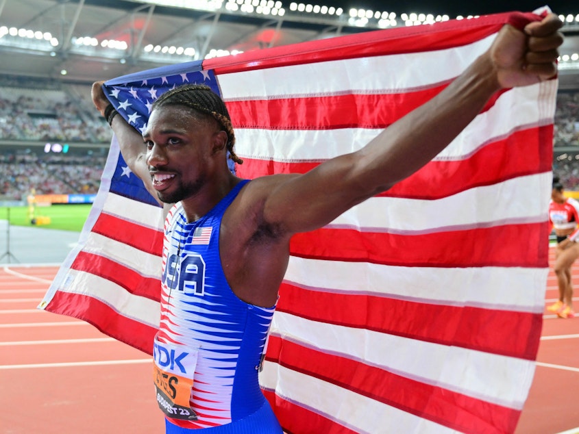caption: Noah Lyles celebrates after anchoring the USA team to victory in the men's 4x100m relay final during the World Athletics Championships at the National Athletics Centre in Budapest on August 26.