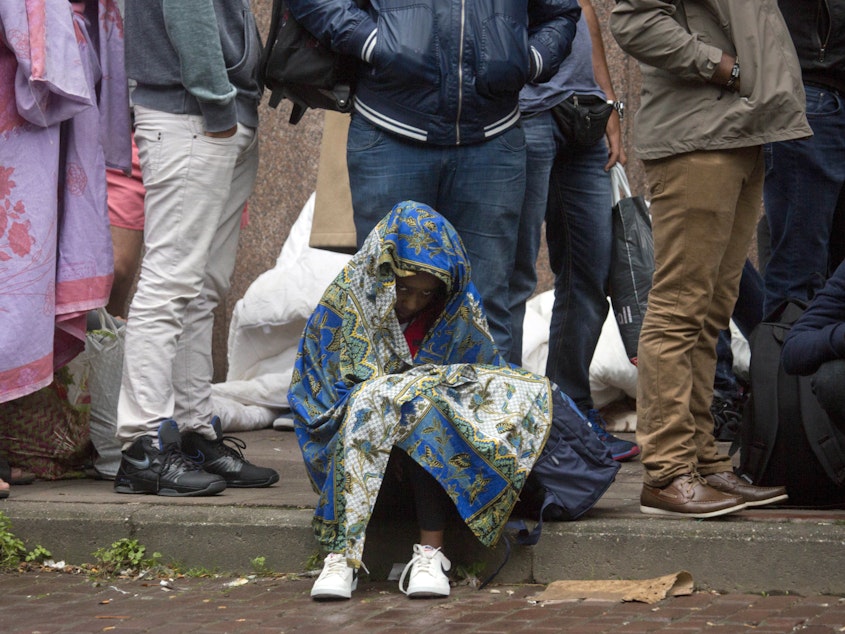 caption: In this Sept. 1, 2015, file photo, a child waits in line at a migrant reception center in Brussels. Belgian migration minister Theo Francken said on Thursday he wants no part of a United Nations pact on safe and orderly migration, an international deal that has pushed Belgium's government to the brink of collapse.
