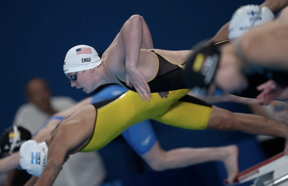 caption: Piper "Lightning" Enge, dives into the pool during a swim meet. Enge is the first female high schooler to swim the 100 meter breaststroke in under 60 seconds.