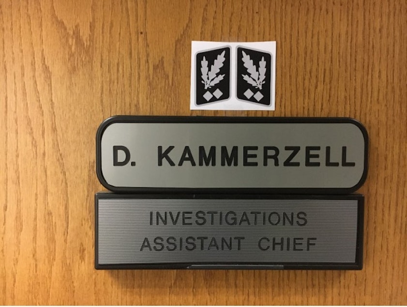 caption: Kent Assistant Police Chief Derek Kammerzell posted Nazi rank insignia on his office door for two weeks in September 2020 until an officer complained.