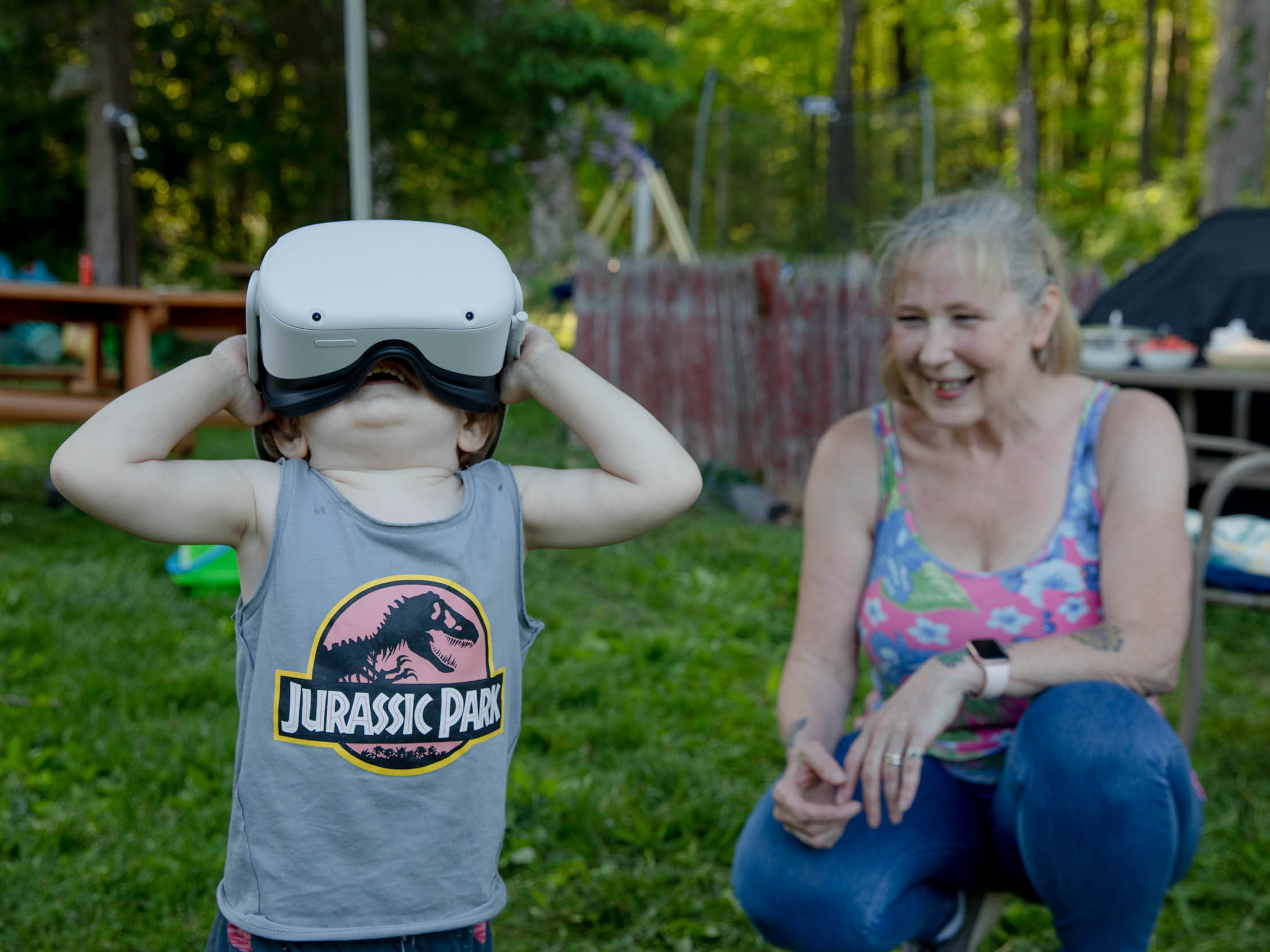 caption: Linda Munson's youngest grandson, Daniel Gomez, 2, tries on an Oculus headset in her yard in Berlin, Conn. Playing different virtual reality games has become her family's regular Sunday activity, Munson said.