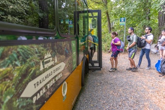 caption: Passengers board one of King County's Trailhead Direct bus services that takes passengers directly from Seattle to their favorite King County trails. 