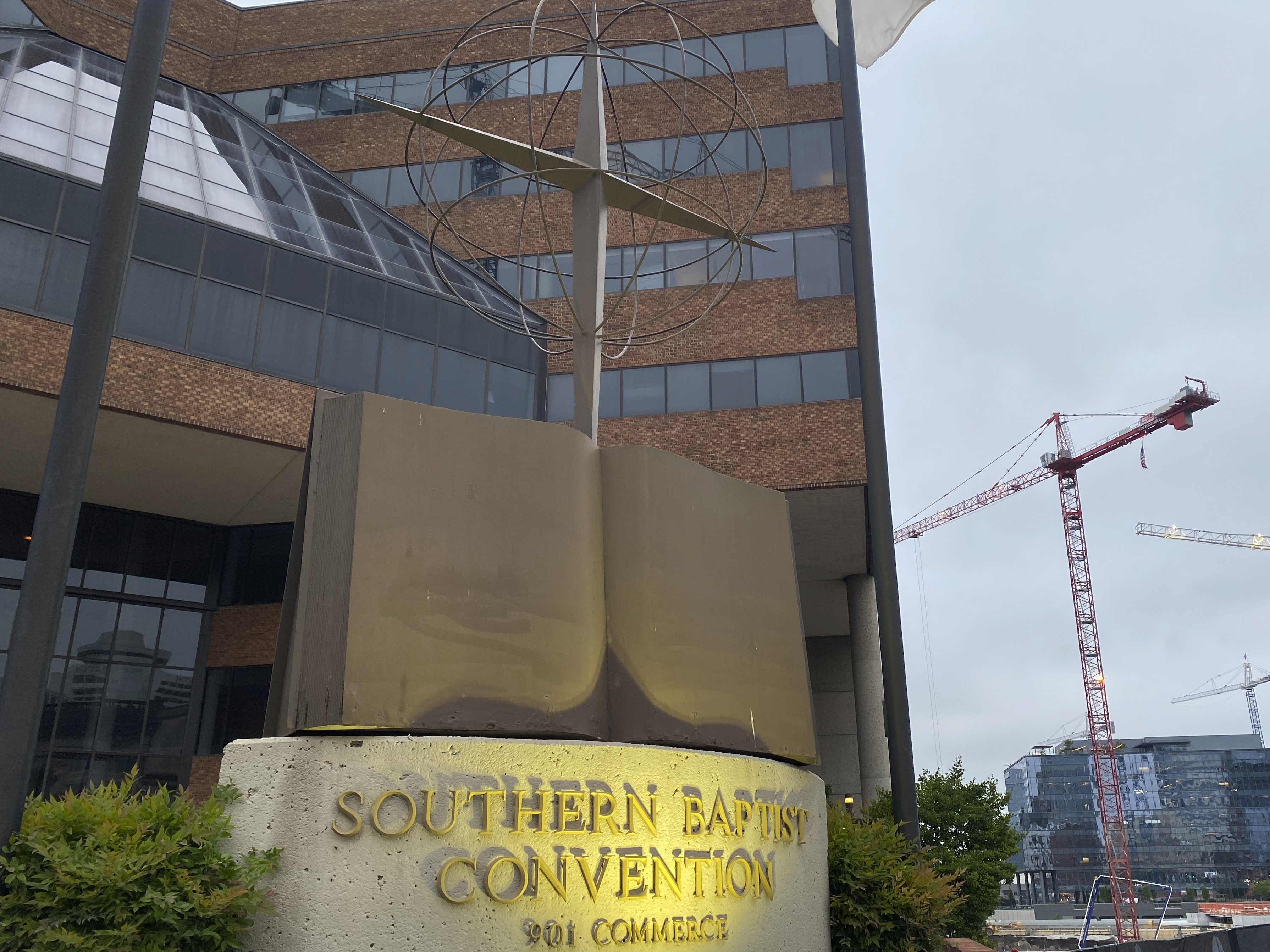 caption: A cross and Bible sculpture stand outside the Southern Baptist Convention headquarters in Nashville, Tenn., on Tuesday. Top administrative leaders for the SBC said that they will release a secret list of hundreds of pastors and other church-affiliated personnel accused of sexual abuse.