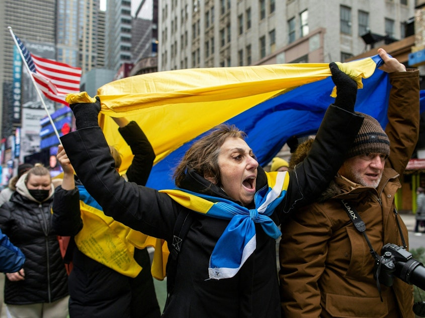 caption: Demonstrators rally in New York City's Times Square in support of Ukraine on Thursday.