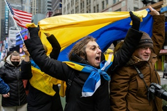 caption: Demonstrators rally in New York City's Times Square in support of Ukraine on Thursday.