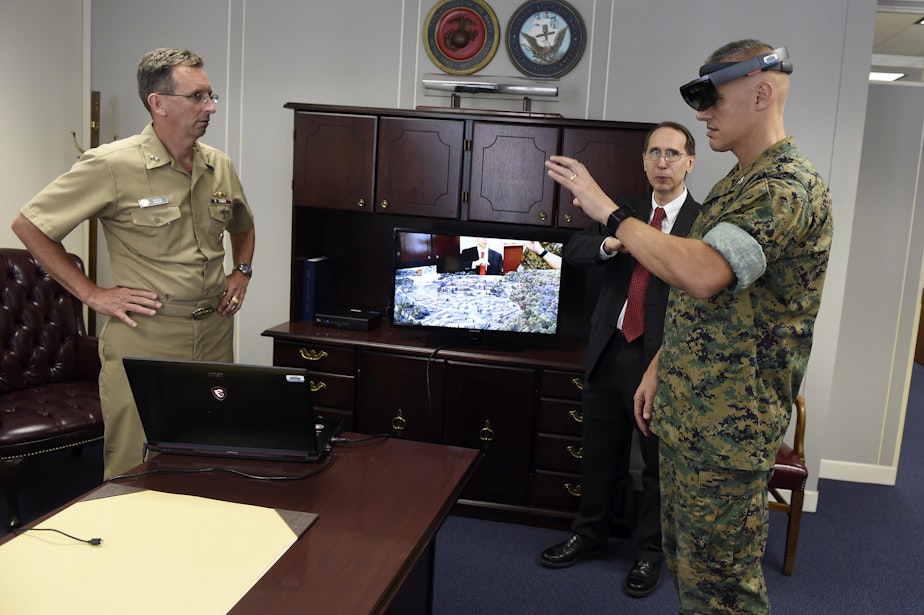 caption: Col. William Bentley, Office of Naval Research deputy for the expeditionary maneuver warfare and combating terrorism department, joins the Chief of Naval Research, Rear Adm. David Hahn, for a demonstration of the "Tactical Decision Kit" that includes a Microsoft HoloLens headset.  