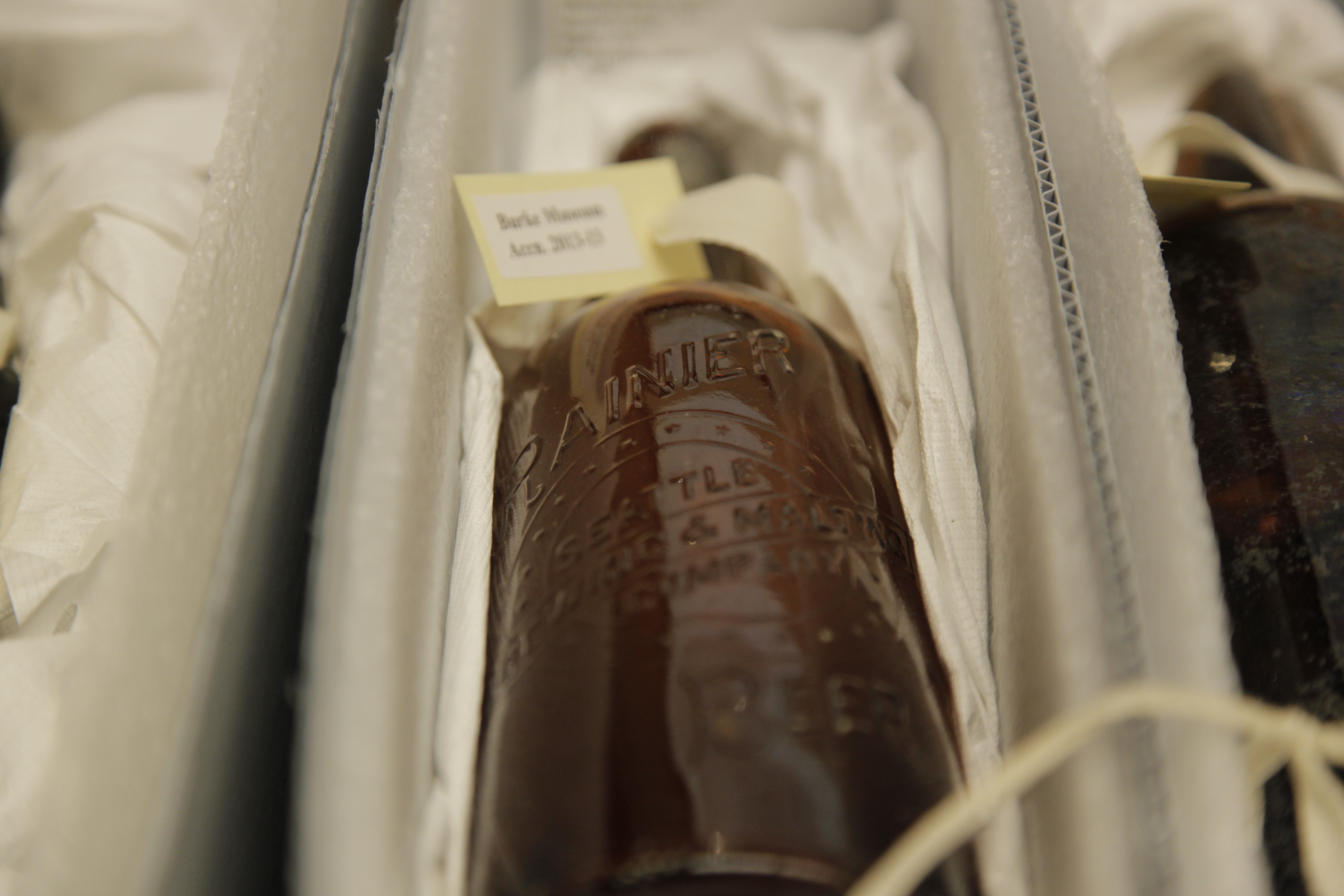 caption: This Rainier bottle from the Seattle Brewing 