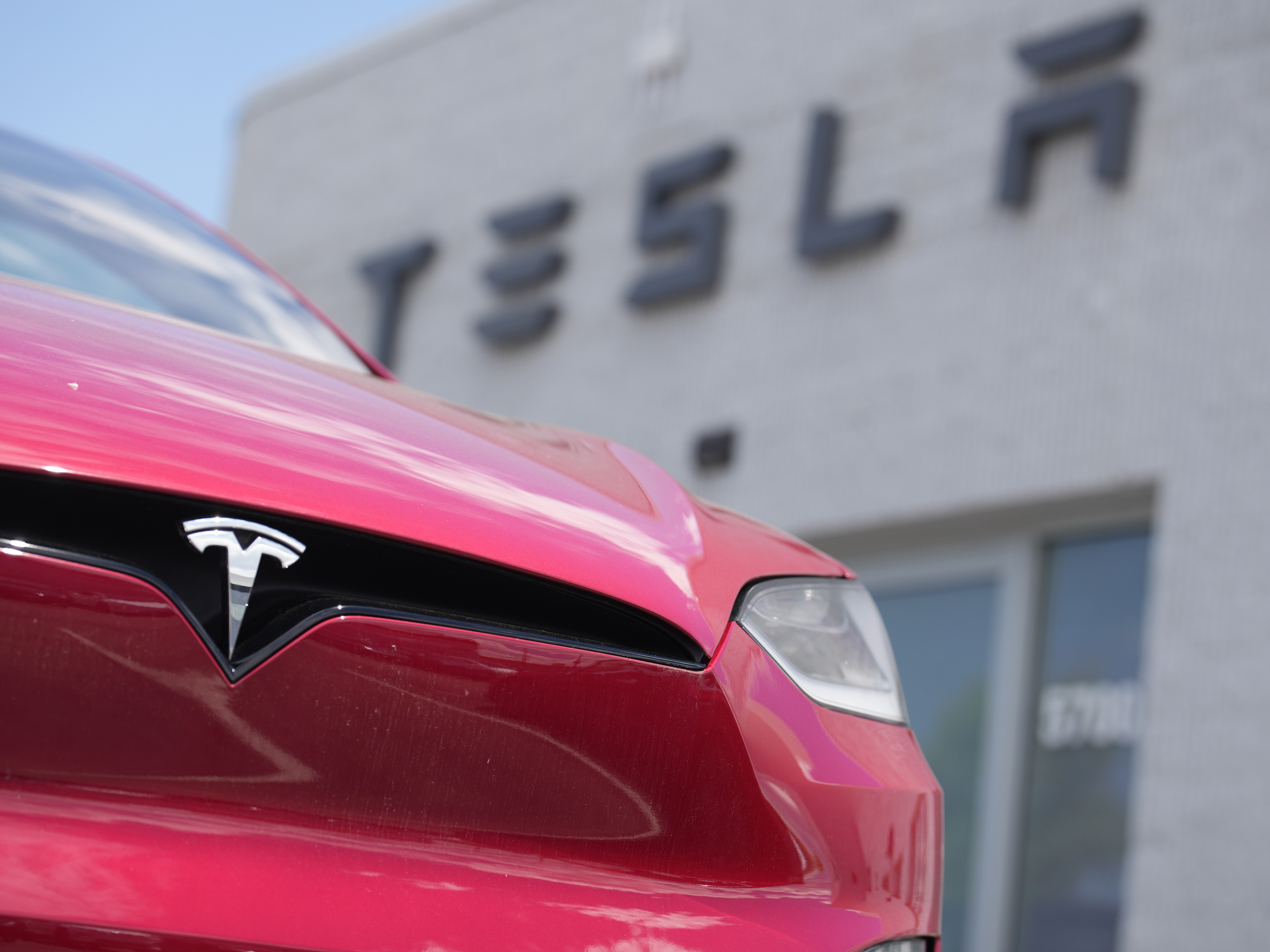 caption: A 2023 Model X sports-utility vehicle sits outside a Tesla dealership Sunday, June 18, 2023, in Littleton, Colo.