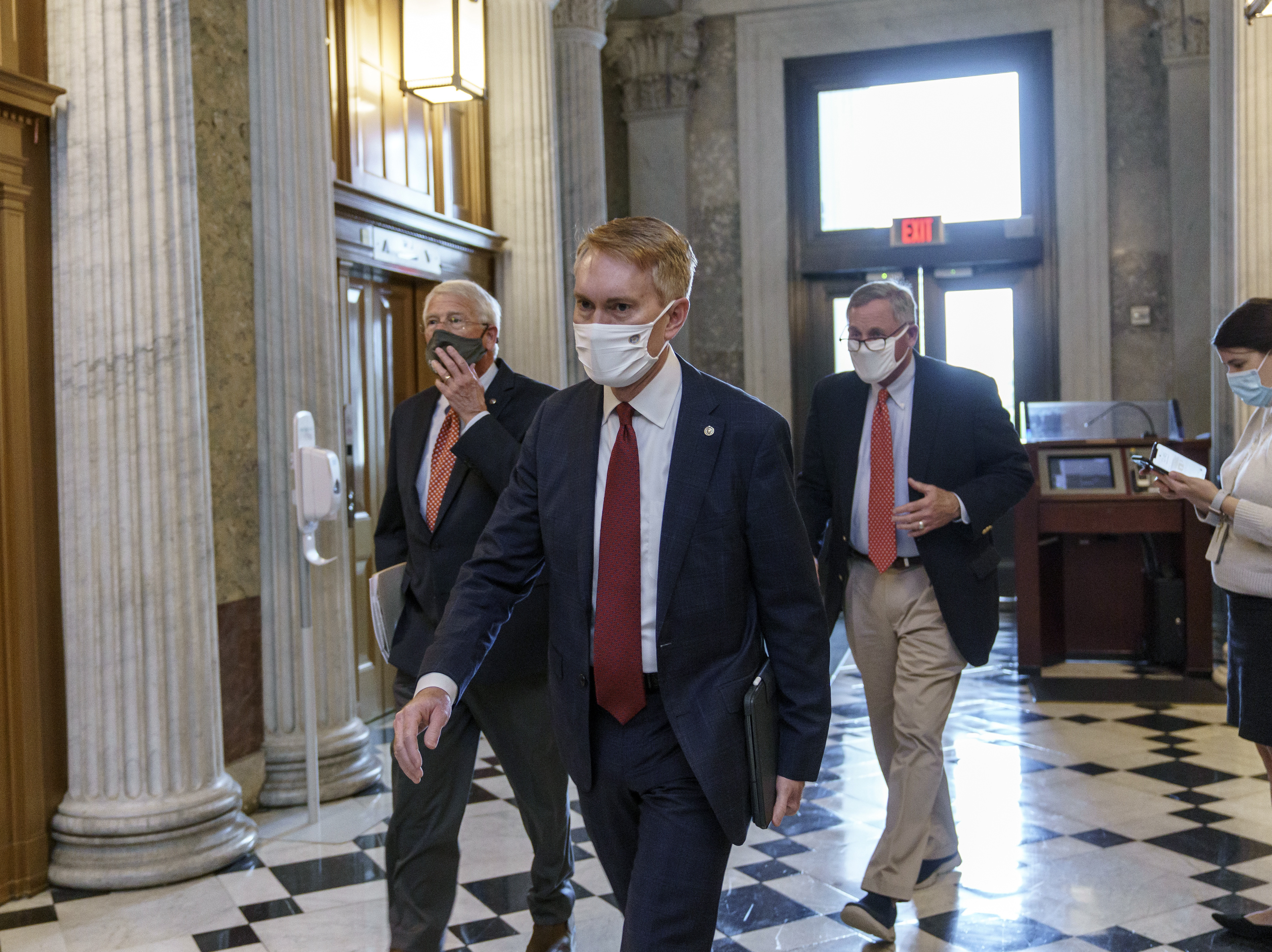 caption: Sen. James Lankford, R-Okla., center, is among the Republican lawmakers supporting a push for President-elect Joe Biden to receive new intelligence briefings as part of his transition to the White House.