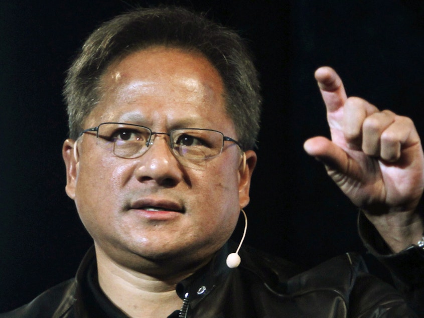 caption: In this file photo, Nvidia CEO Jensen Huang delivers a speech about AI and gaming.