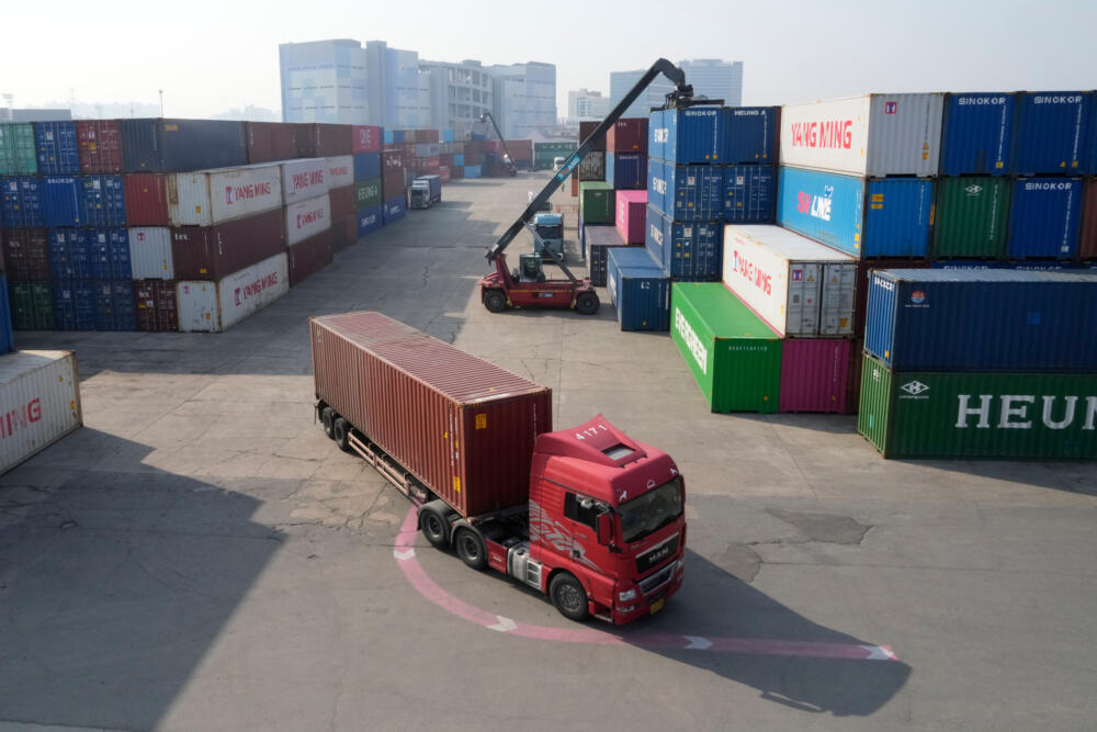 caption: A truck runs by containers at the Uiwang ICD Terminal in Uiwang, South Korea, Thursday, March 12, 2026. (Ahn Young-joon/AP)