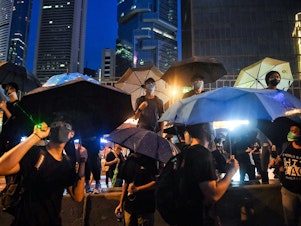 caption: Protesters gather for a rally Sunday in Hong Kong. Many of the pro-democracy demonstrators have brandished umbrellas, in a nod to a symbol widely used during the semi-autonomous city's massive 2014 protests.